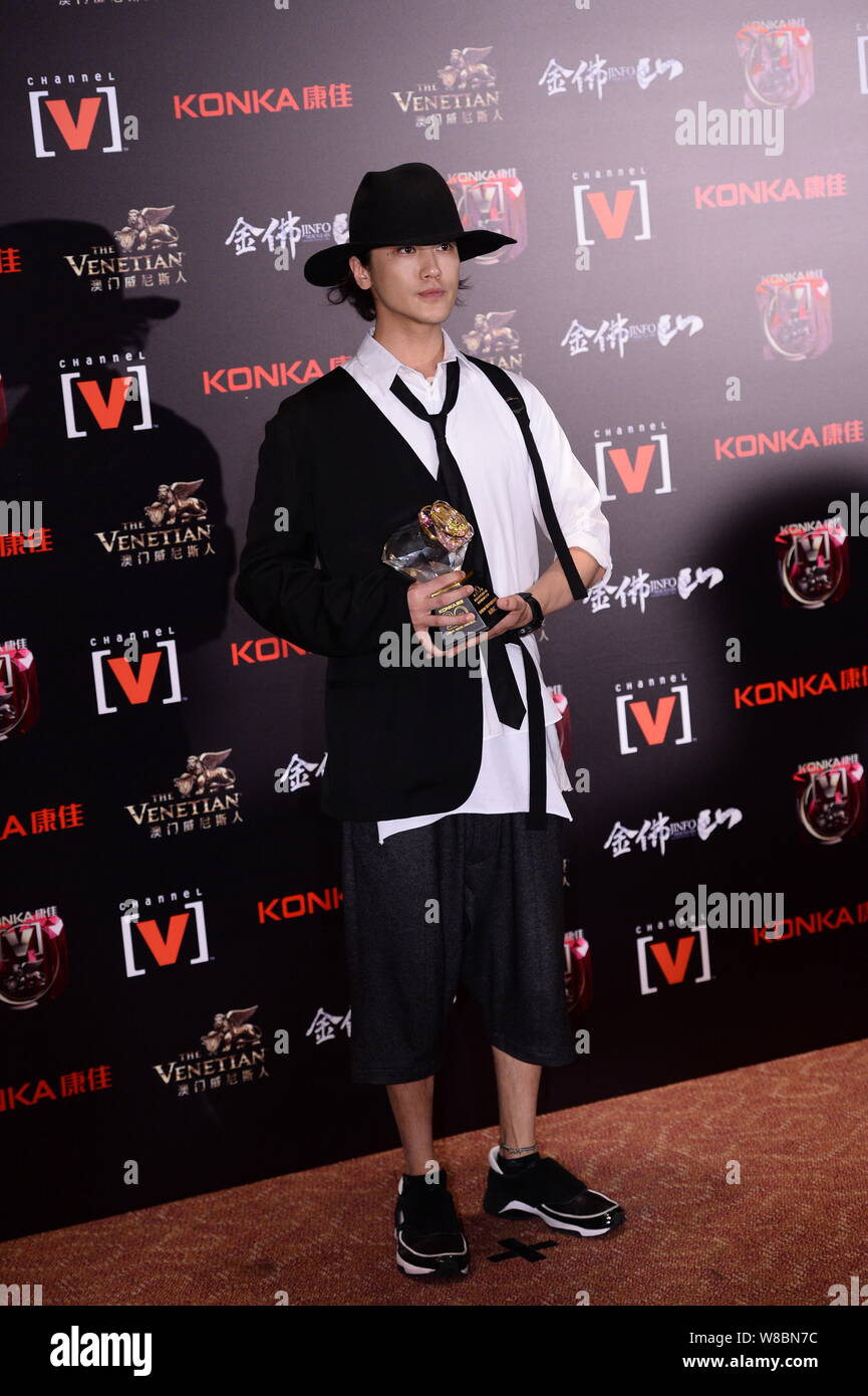 Japanese singer Jin Akanishi poses with his trophy after the