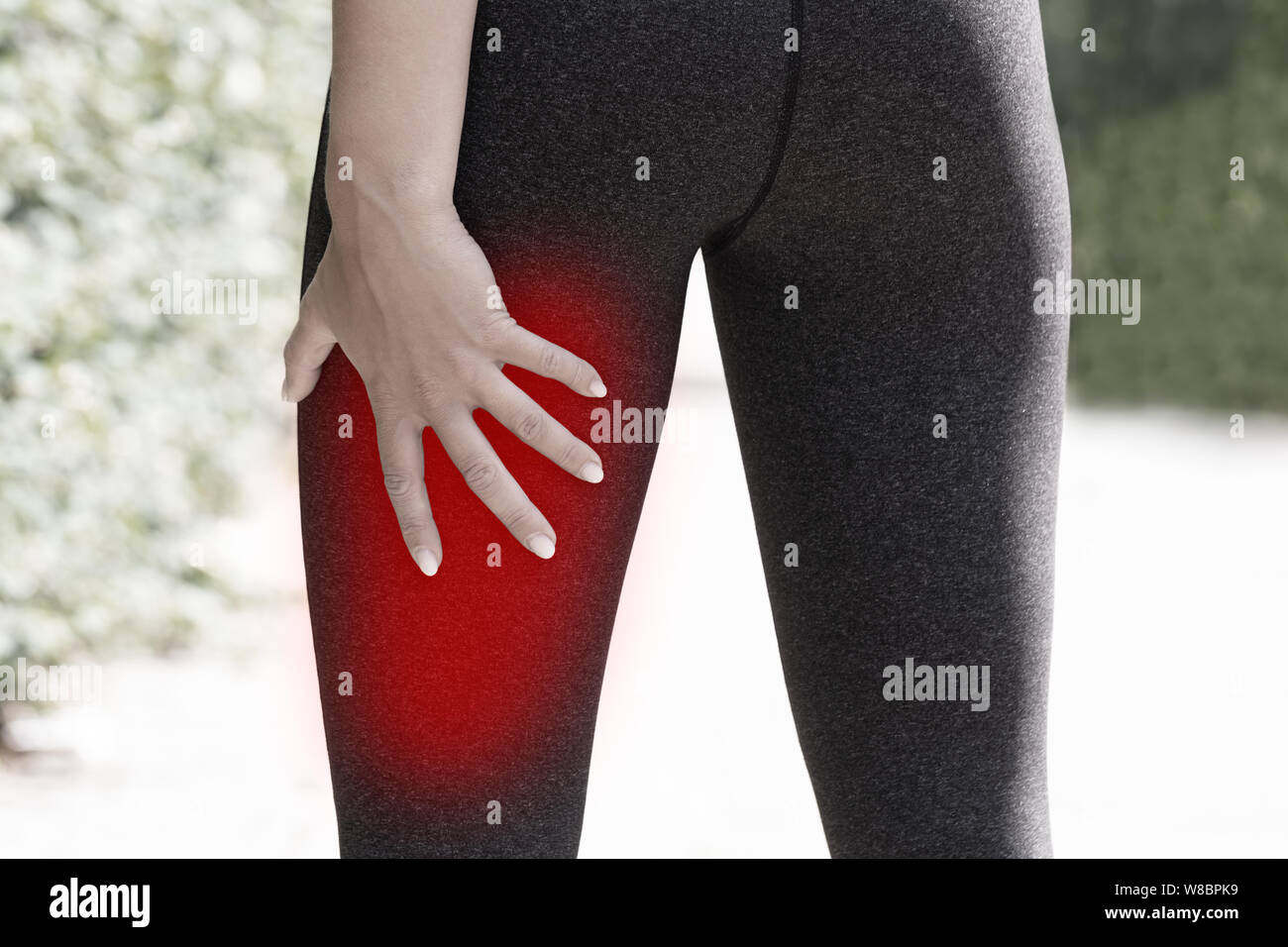 Close-up Of A Female Runner Holding His Injured Leg Stock Photo