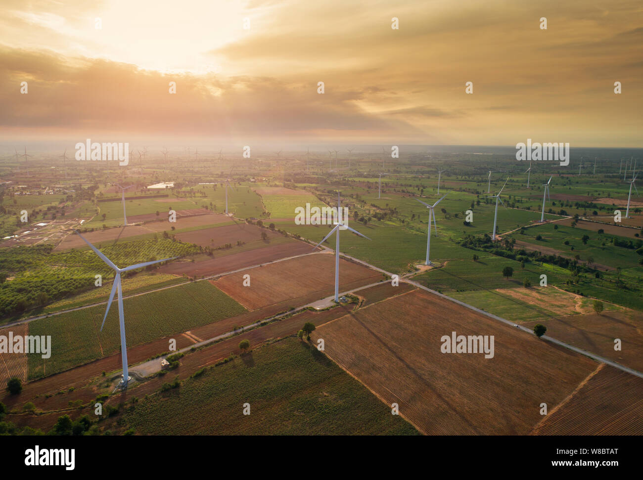 Aerial view of large wind turbines at sunrise taken from the air. wind ...