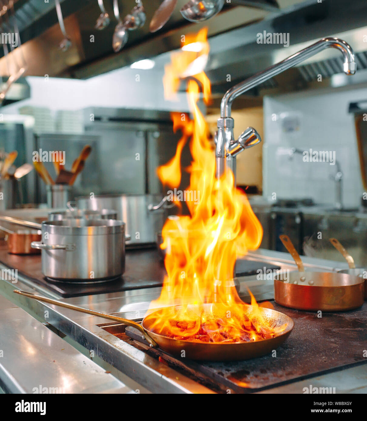 Modern kitchen. Cooks prepare meals on the stove in the kitchen of the ...