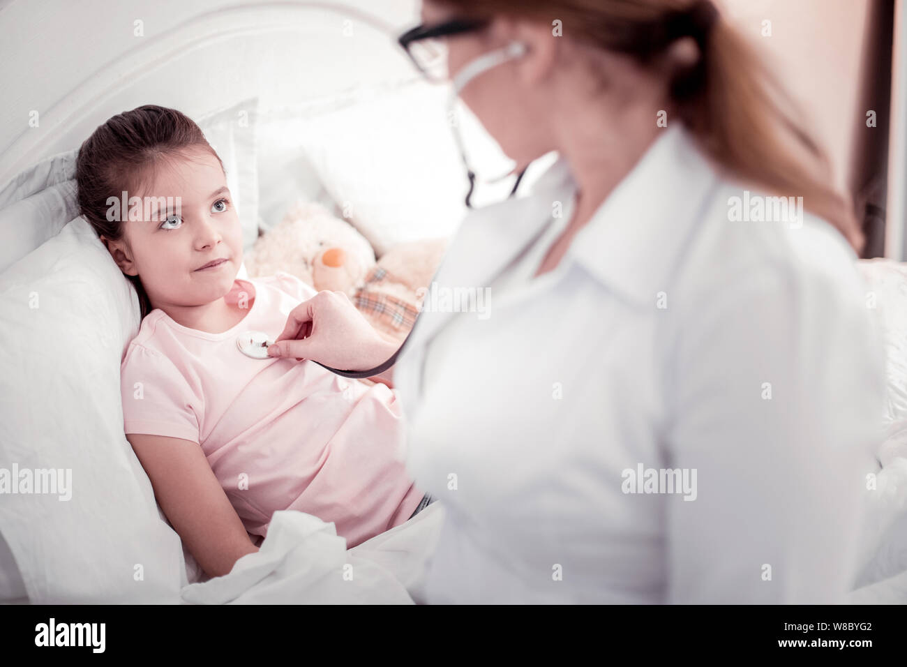 Professional smart female therapist using her stethoscope Stock Photo