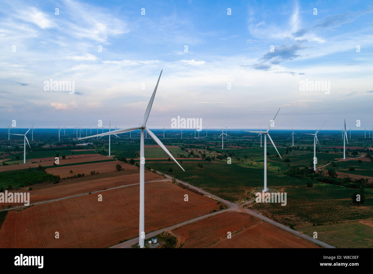 Aerial view of large wind turbines at sunrise taken from the air. wind ...