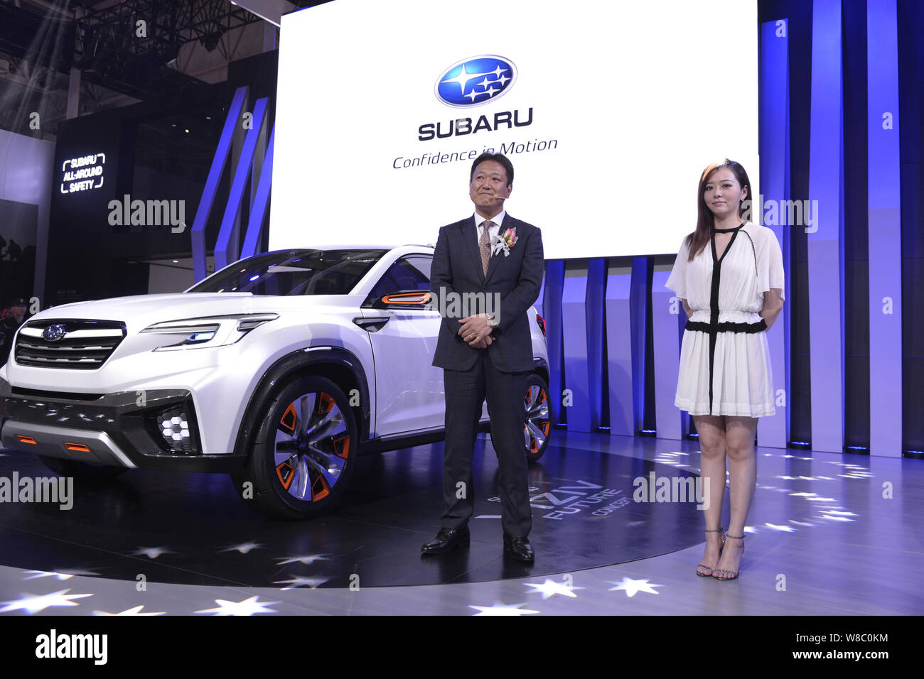 Chinese singer Zhang Liangying, right, poses with a Subaru Viziv Future SUV during the 14th Beijing International Automotive Exhibition, also known as Stock Photo