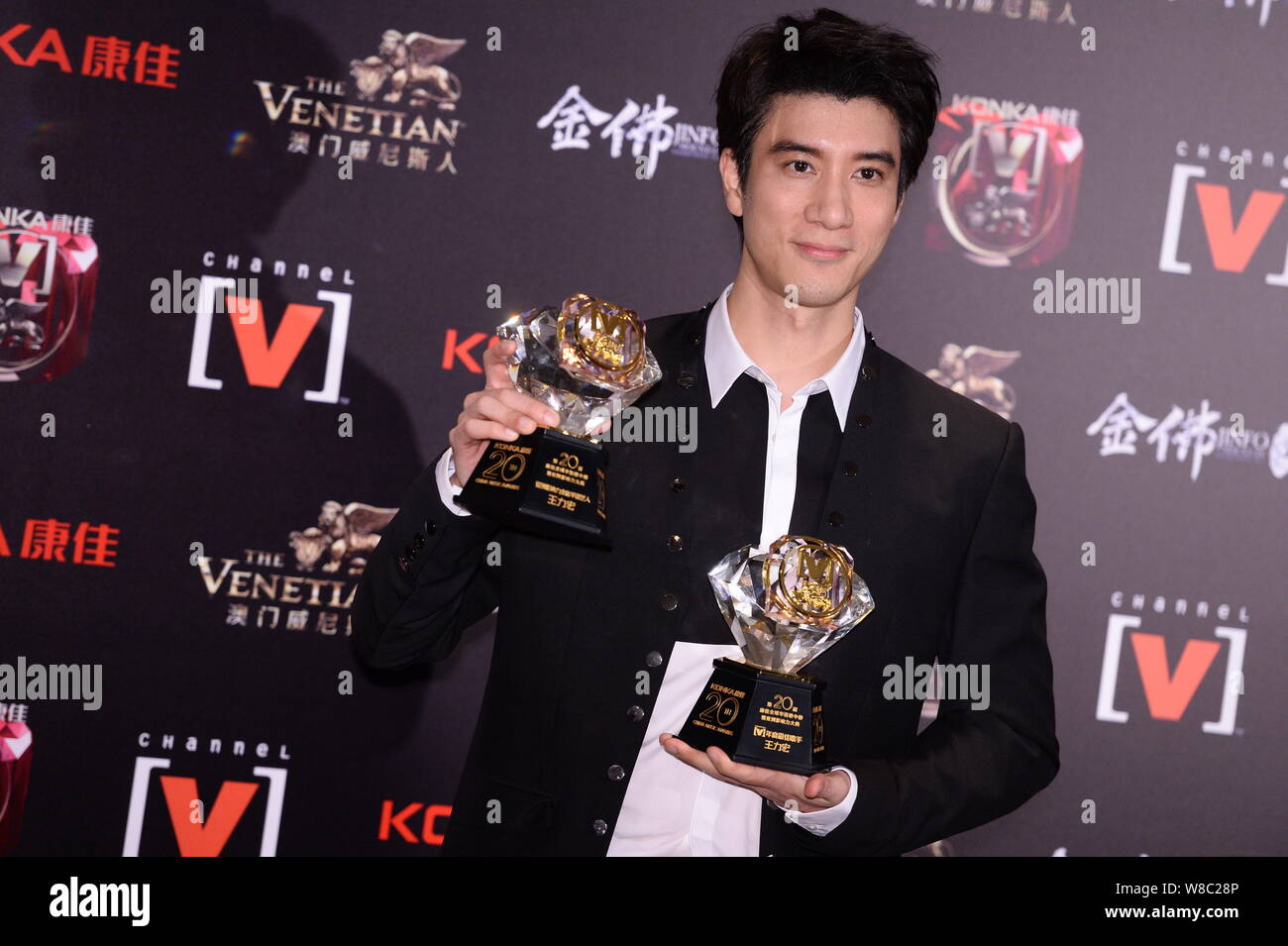 Taiwanese singer Leehom Wang poses with his trophies after the 20th