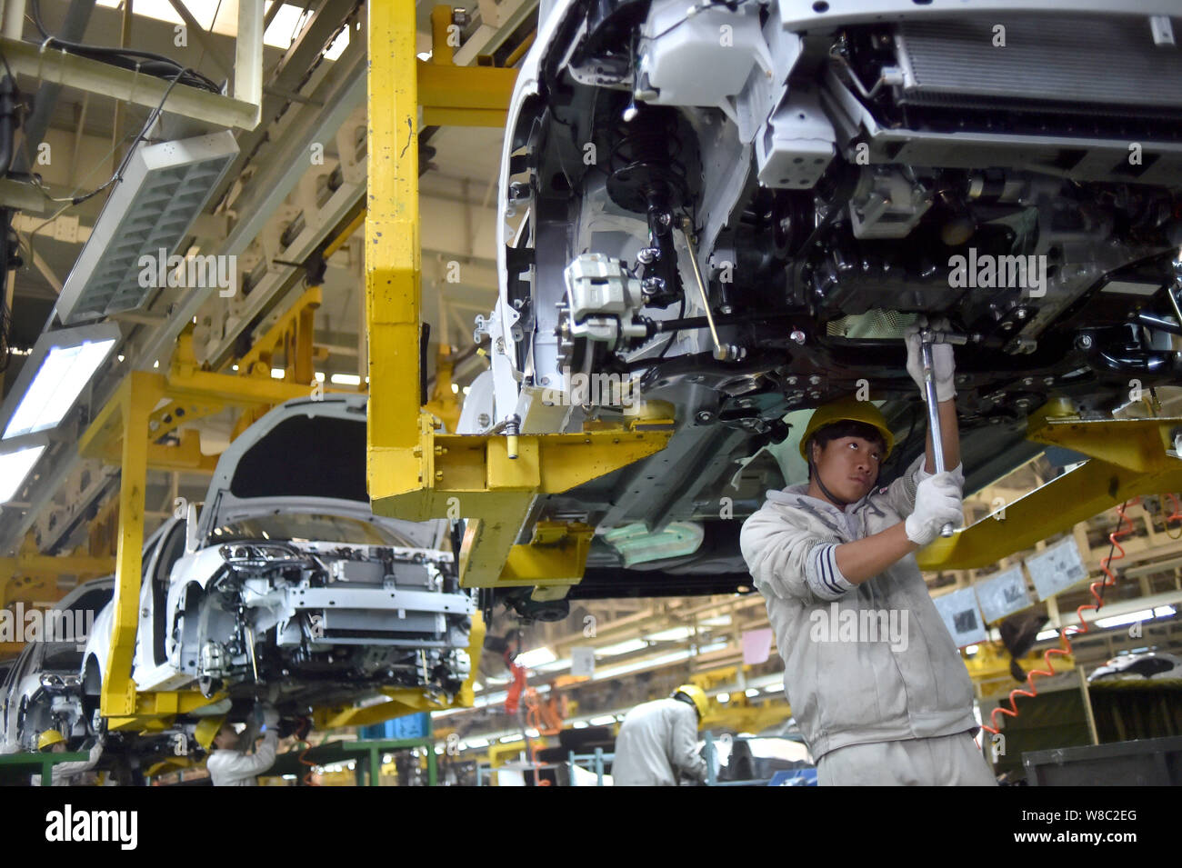--FILE--Chinese workers assemble cars on the assembly line at an auto ...