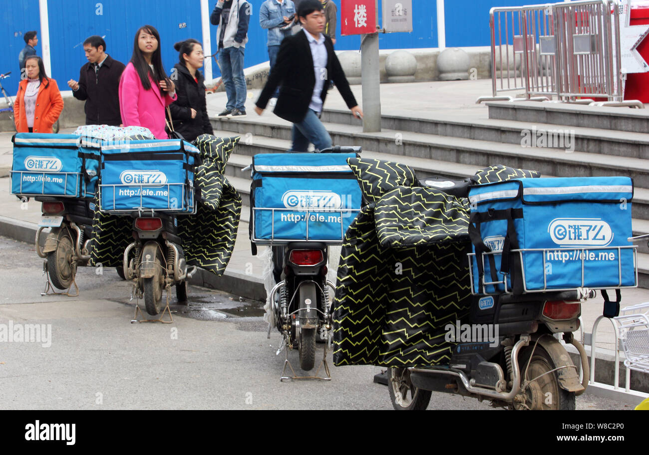 FILEPedestrians walk past electric bikes of deliverymen of Chinese