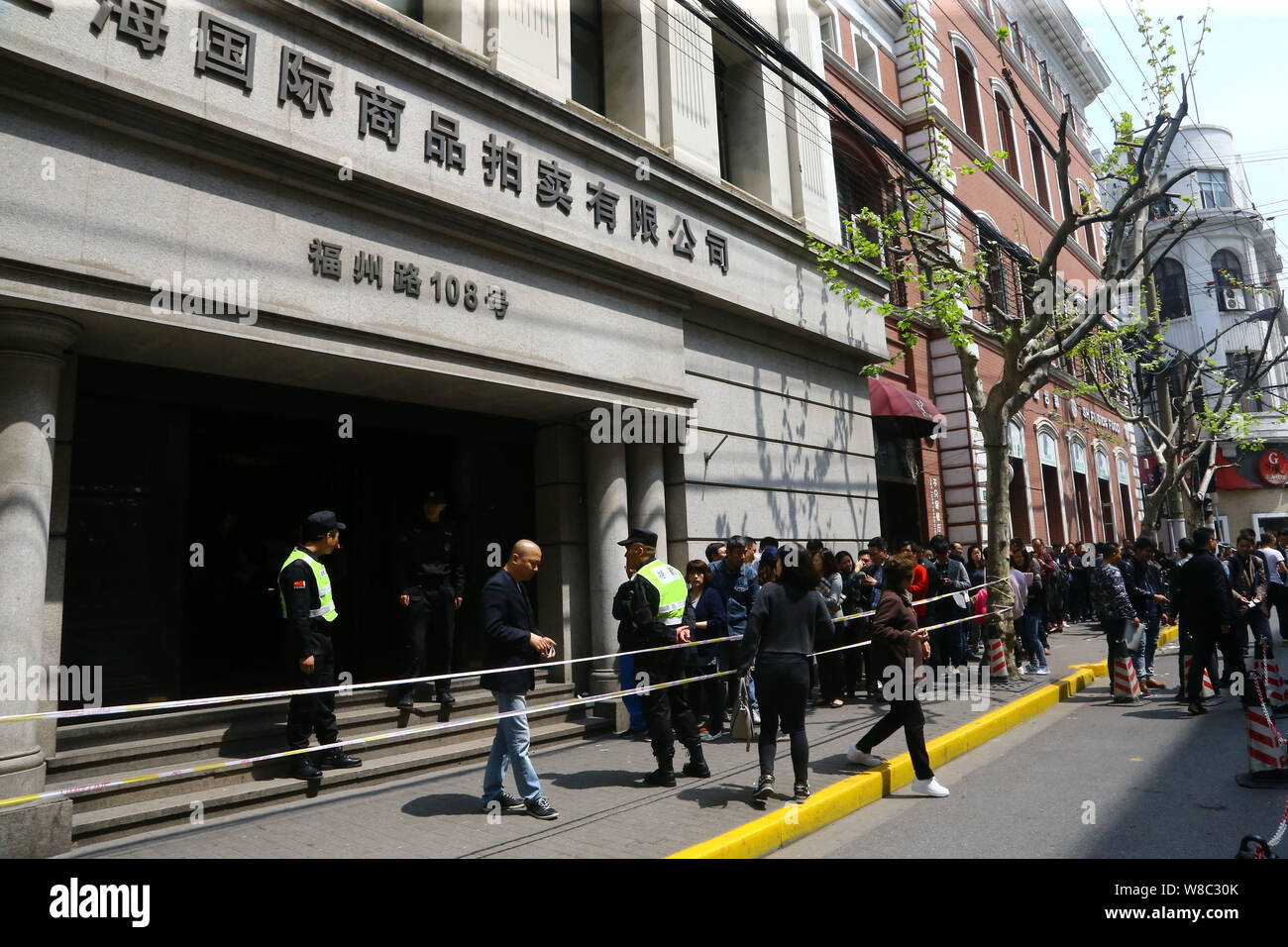 Applicants queue up to purchase the bidding document for vehicle license plate auctions in front of Shanghai International Commodity Auction Co., Ltd. Stock Photo