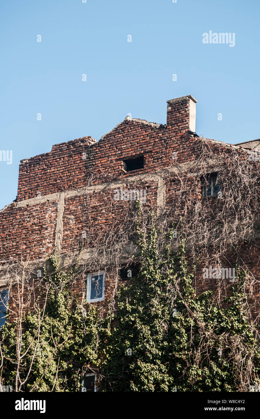 Backside old weathered vintage brick building wall facade Stock Photo