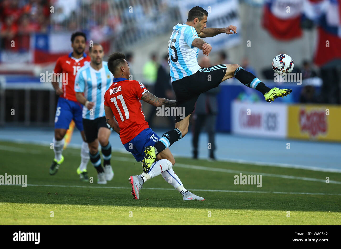 Chile's Eduardo Vargas, front left, challenges Argentina's Martin Demichelis, right, during the Copa America 2015 final soccer match between Chile and Stock Photo