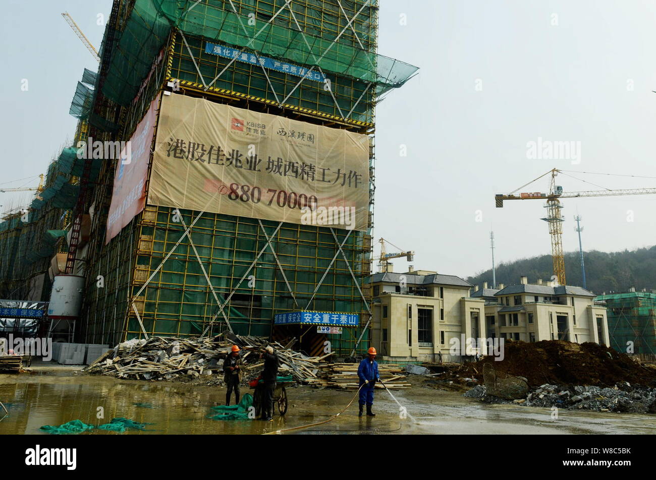 --FILE--Chinese migrant workers labor at the construction site of the residential property project 'Majestic Mansion Jade Garden' developed by Kaisa G Stock Photo