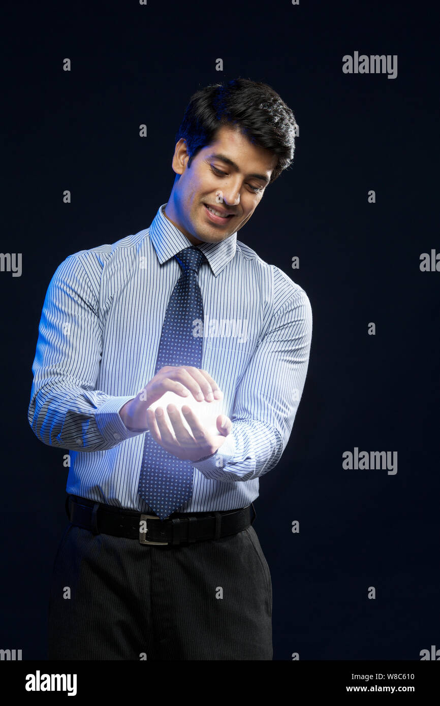 Businessman holding a ball of light Stock Photo