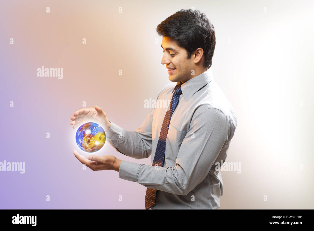 Businessman with a globe of circuits Stock Photo