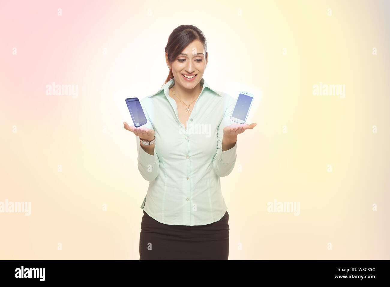 Businesswoman comparing two smart phones Stock Photo
