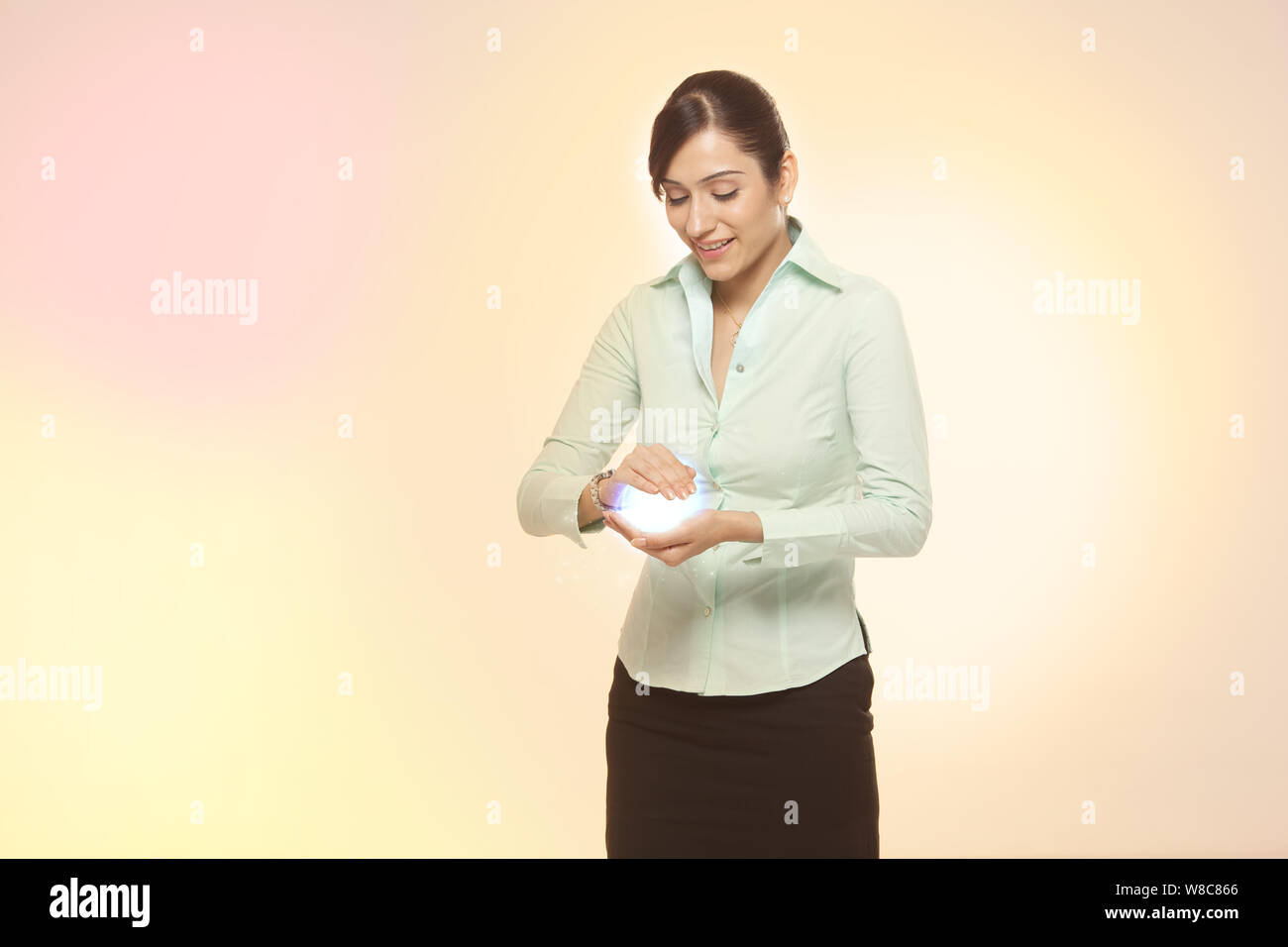 Businesswoman holding a ball of light Stock Photo
