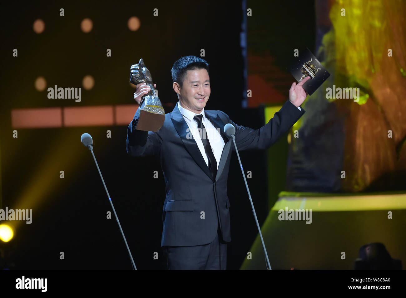 Chinese actor Wu Jing holds his trophy at the award ceremony for the