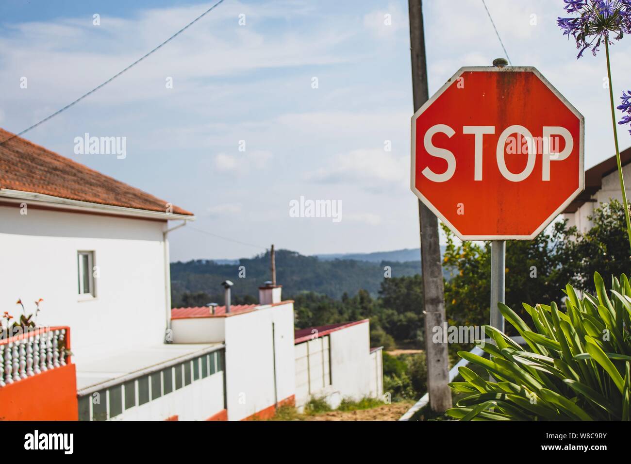 Stop sign with a beautiful background. Peaceful rural area view. Summer holidays feeling. Stock Photo