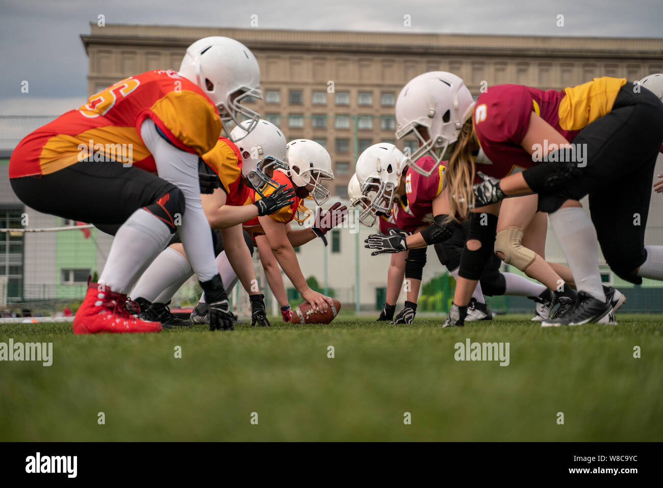 Image of female team in helmets playing rugby on playground Stock Photo Alamy