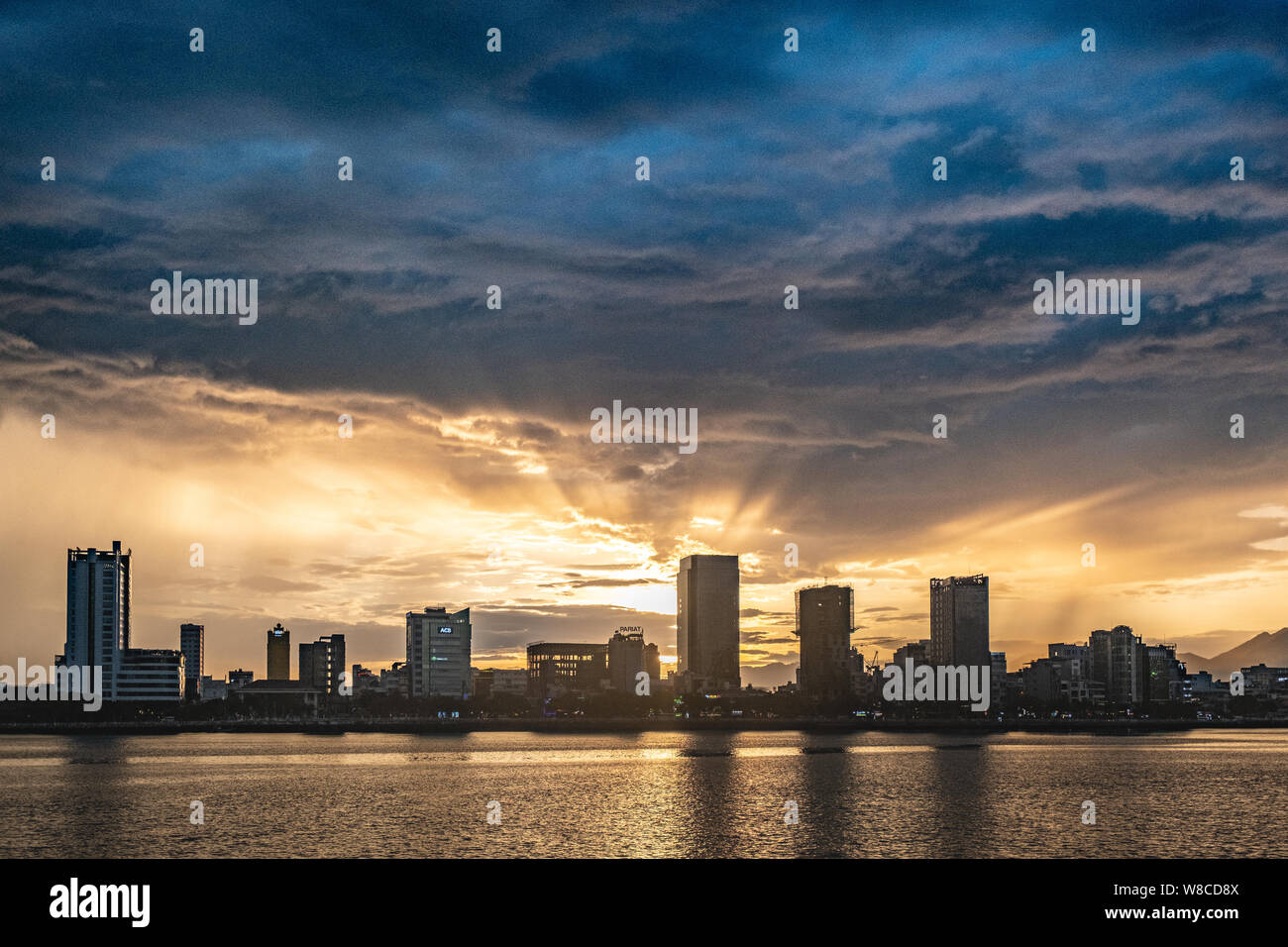 Beautiful sunset over  Đà Nẵng city in central Vietnam with heavy clouds above Stock Photo