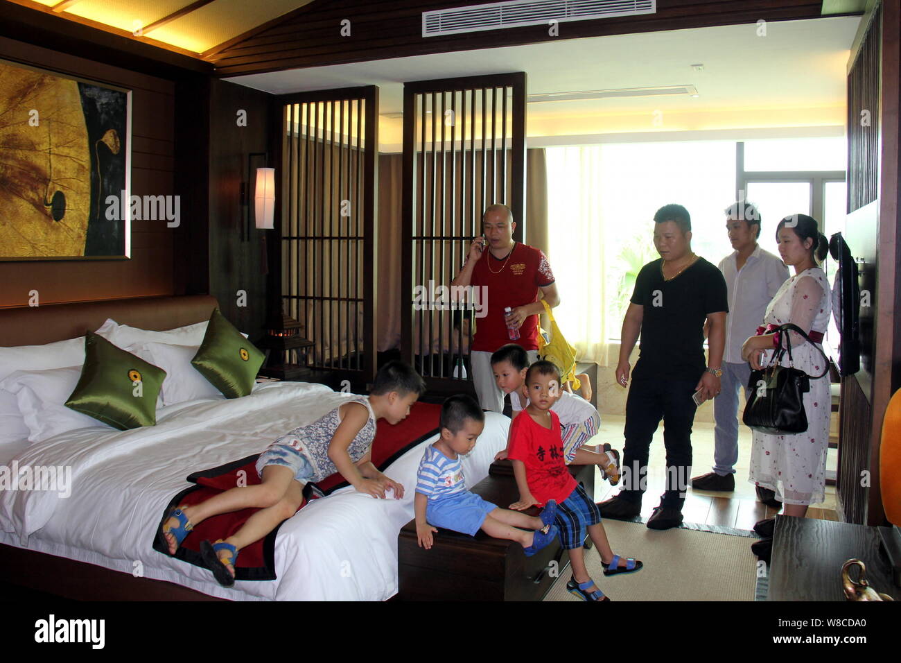 Chinese Parents And Their Children Visit A Bedroom Of A