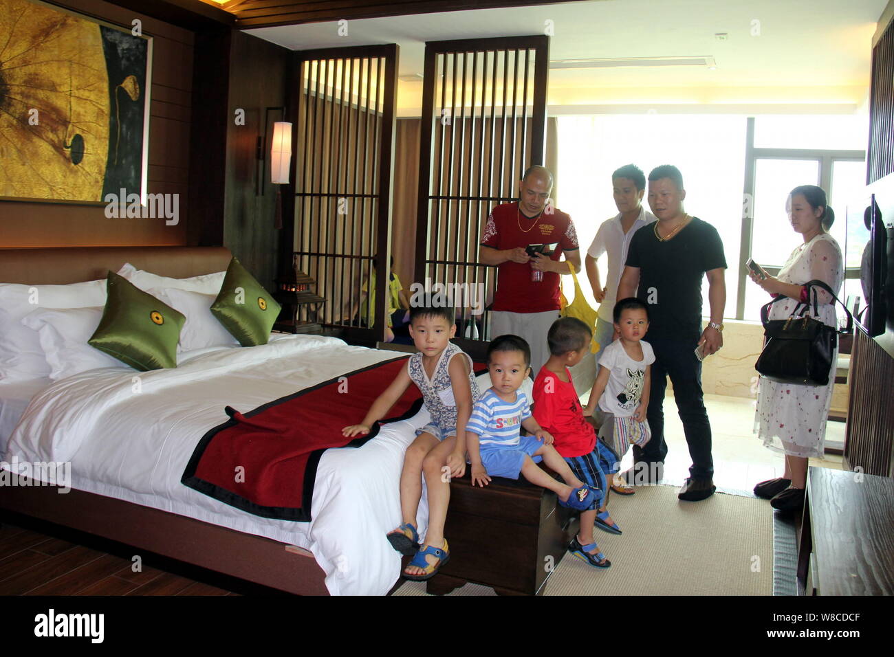 Chinese Parents And Their Children Visit A Bedroom Of A