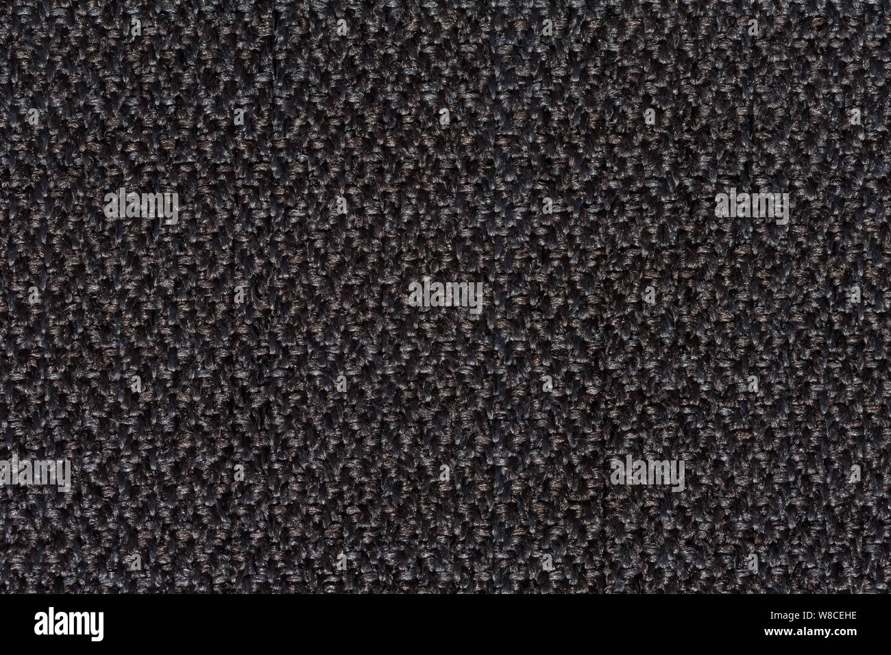 Black textile background with relief surface on macro. Stock Photo