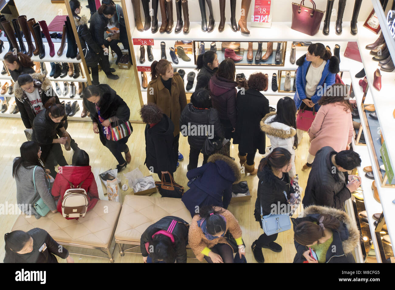 --FILE--Customers buy shoes at a shopping mall in Nanjing city, east China's Jiangsu province, 7 March 2015.   China's retail sales grew 10.1 percent Stock Photo