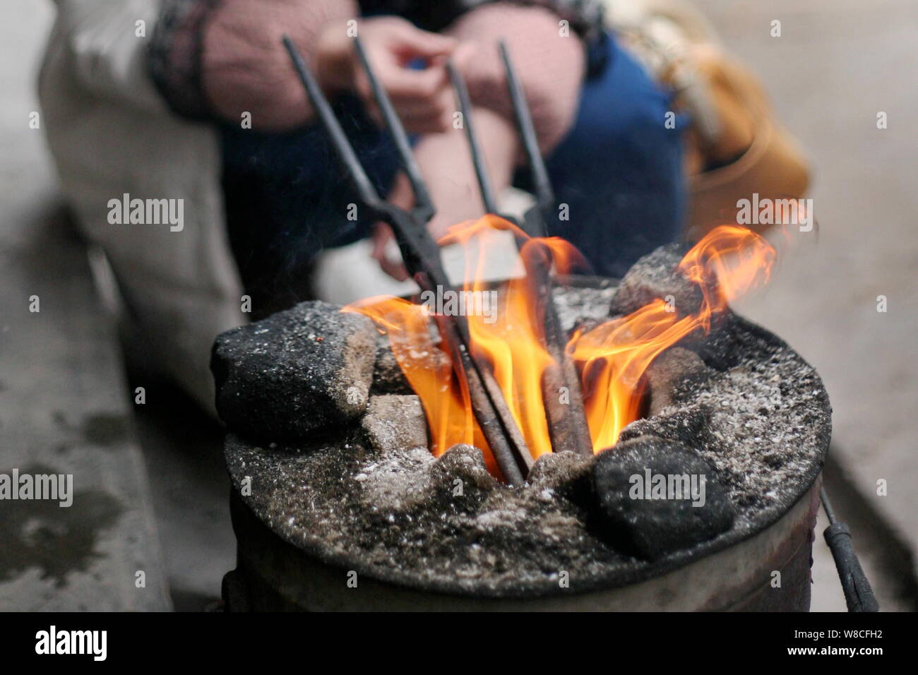 Fire Tongs Are Being Heated Up Before They Are Used To Perm Hair Of Customers At Chinese Barber Wang Weimei S Shop In Jinshi Town Santai County Mian Stock Photo Alamy