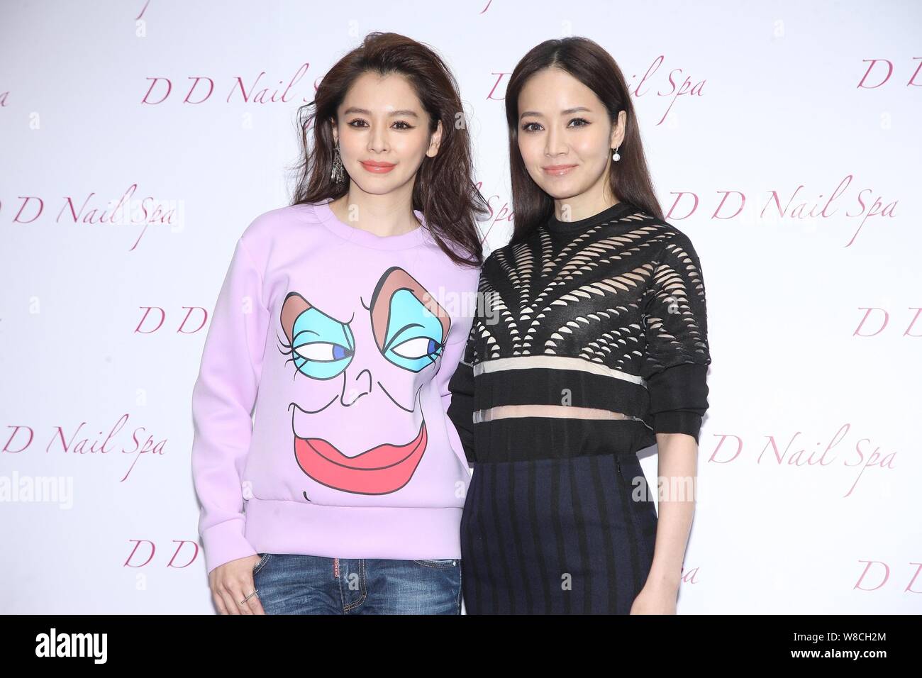 Taiwanese actress Vivian Hsu, left, and TV hostess Patty Hou pose at