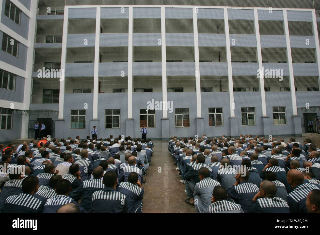 --FILE--Chinese police officers speak to prisoners transferred from the old Leimaping Prison in Leshan city at a new prison in Fuxi town, Emeishan cit Stock Photo