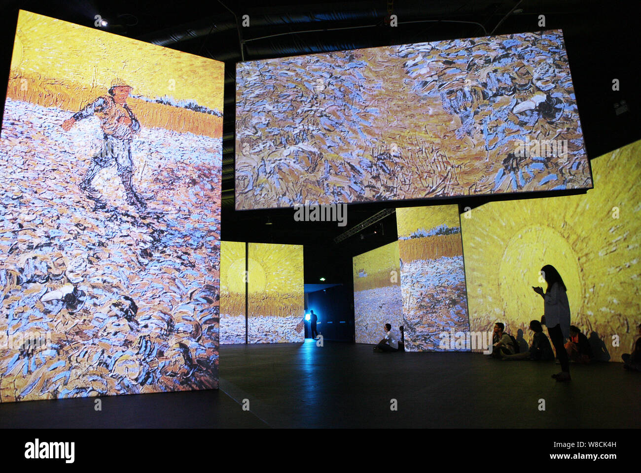 Visitors enjoy a multimedia exhibit of Dutch artist Vincent Van Gogh's ...