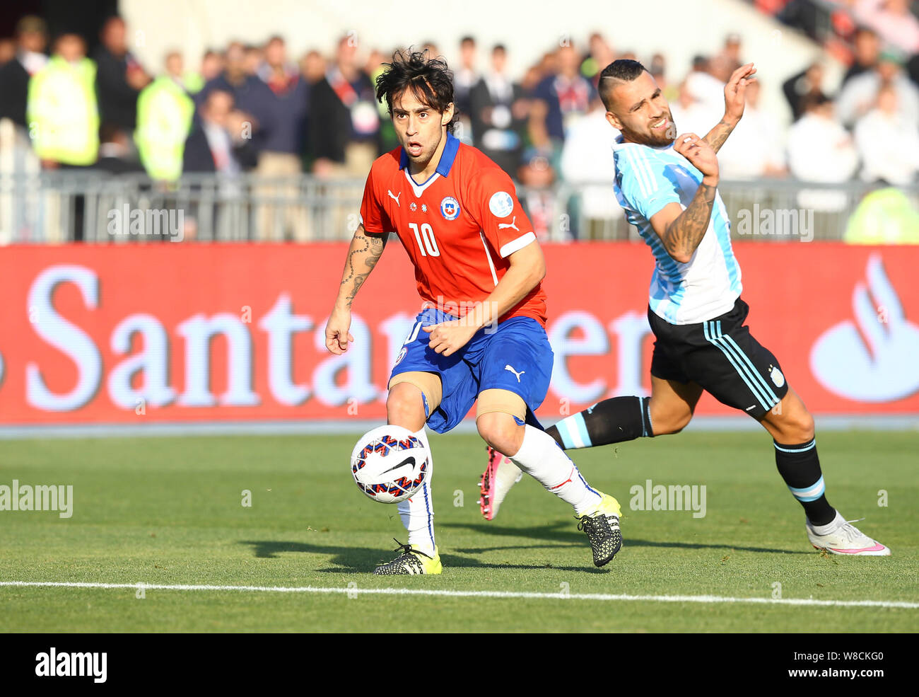 Chile's Jorge Valdivia, left, breaks through Argentina's Nicolas Otamendi, right, during the Copa America 2015 final soccer match between Chile and Ar Stock Photo