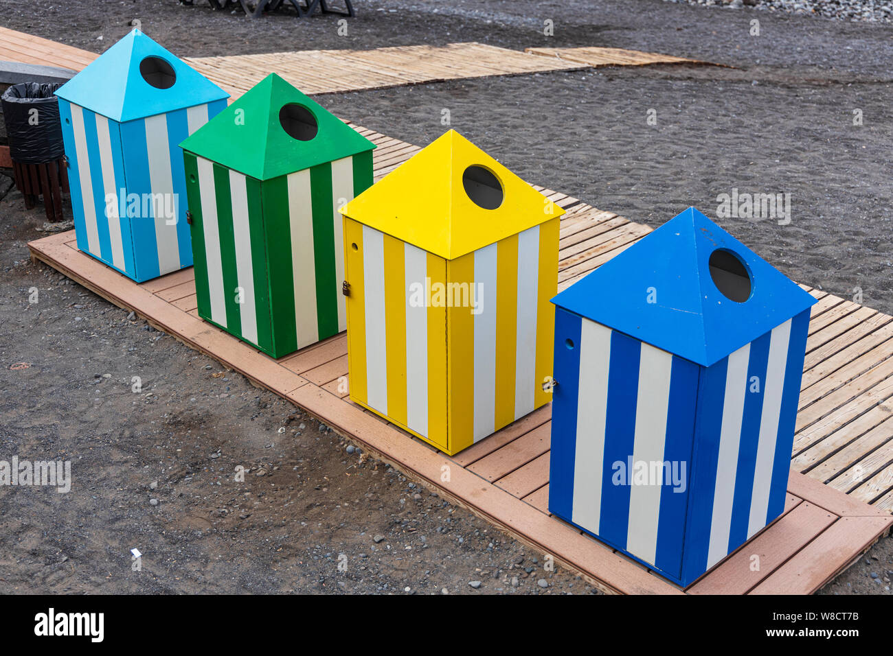 Coloured recycling waste bins on the beach for collecting and seperating refuse, Playa San Juan