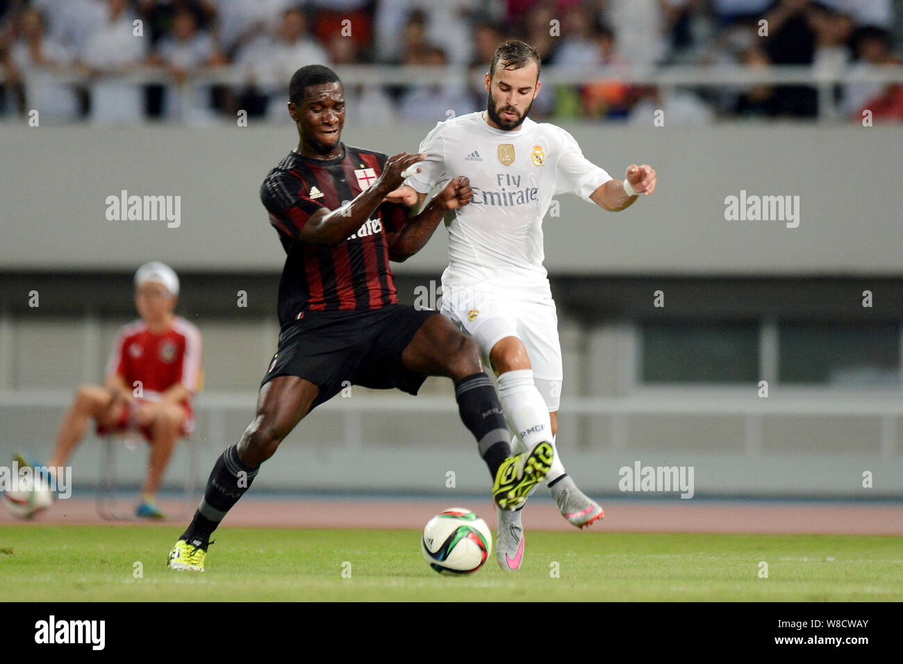 Jese of Real Madrid, right, challenges Cristian Eduardo Zapata Valencia of AC Milan during the Shanghai match of the International Champions Cup 2015 Stock Photo