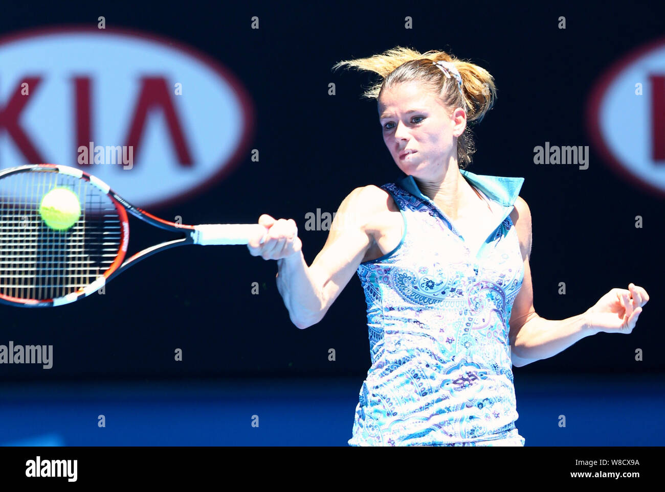 Camila Giorgi of Italy returns a shot to Venus Williams of the U.S. during their third round match at the Australian Open tennis tournament in Melbour Stock Photo