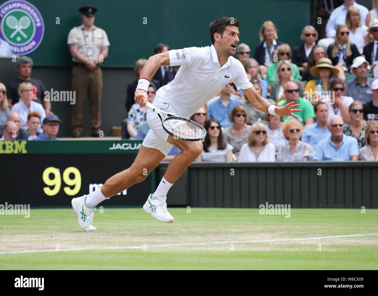 Serbian tennis player Novak Djokovic running forward during 2019 Wimbledon Championships, London, England, United Kingdom Stock Photo