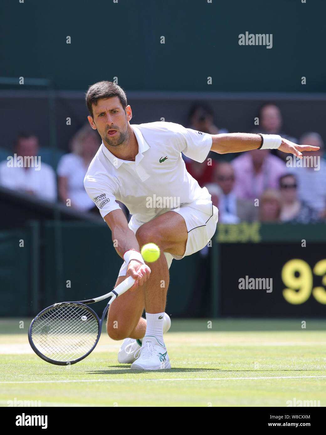 Serbian tennis player Novak Djokovic playing forehand shot during 2019 Wimbledon Championships, London, England, United Kingdom Stock Photo