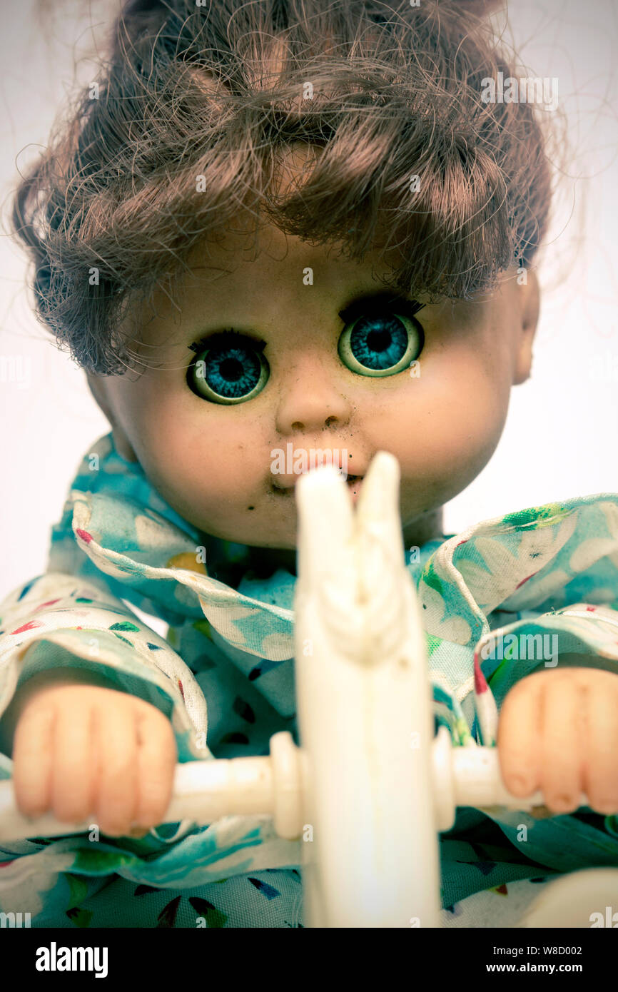 creepy doll on rocking horse