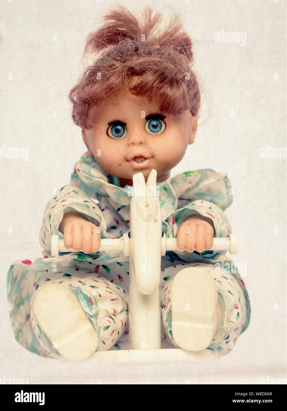 creepy doll on rocking horse