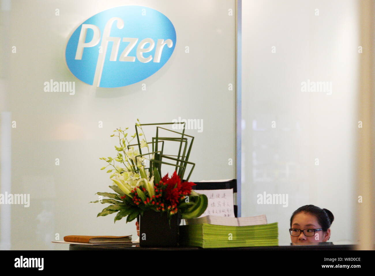 File A Chinese Employee Works At The Front Desk Of The Shanghai