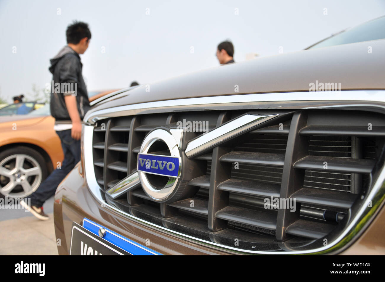 --FILE--Visitors look at Volvo cars at an automobile exhibition in Qingdao city, east China's Shandong province, 5 May 2012.   Sweden's truck maker Vo Stock Photo