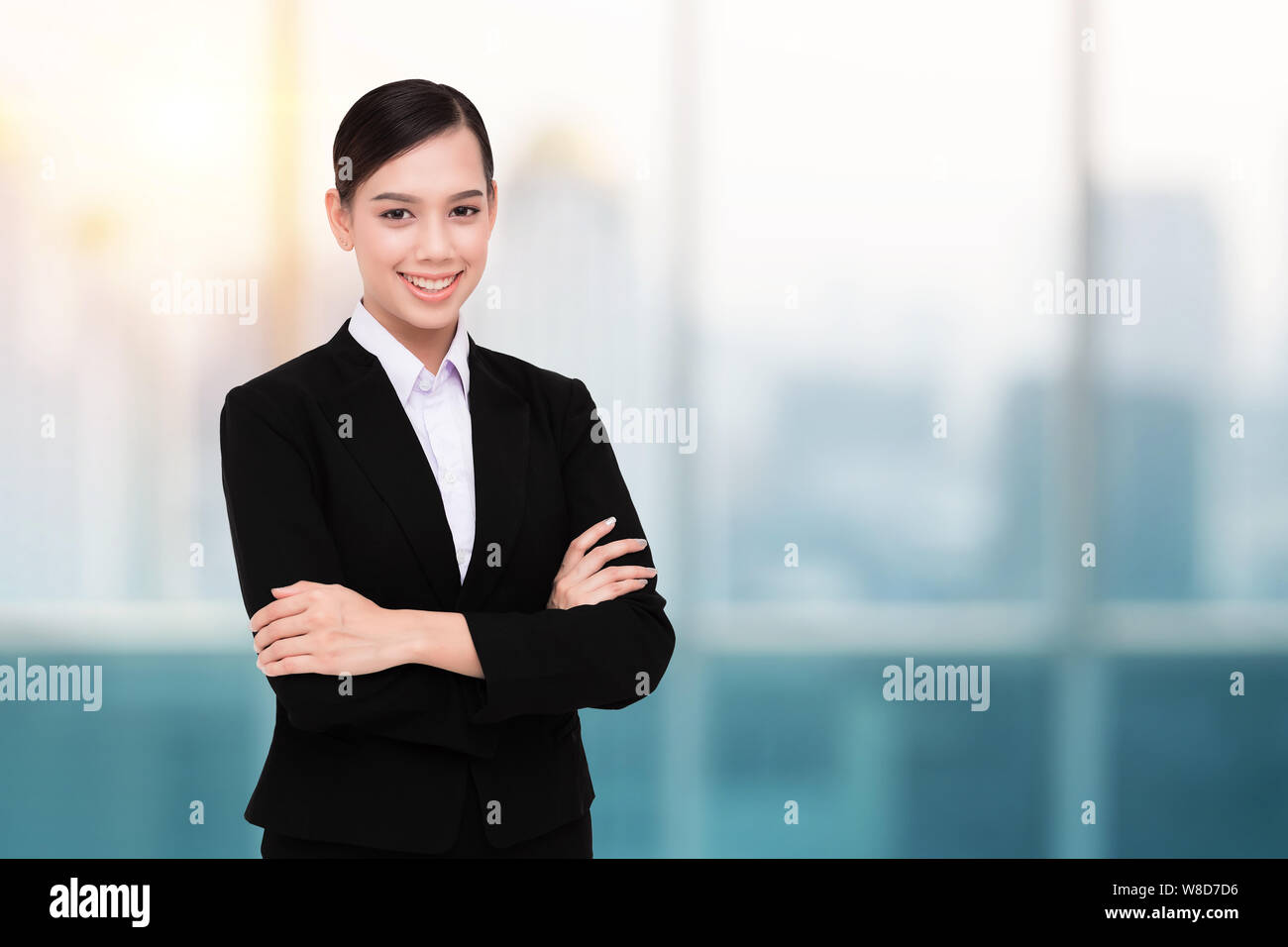 Smiling Pretty Business Woman With Arms Crossed Stock Photo - Alamy