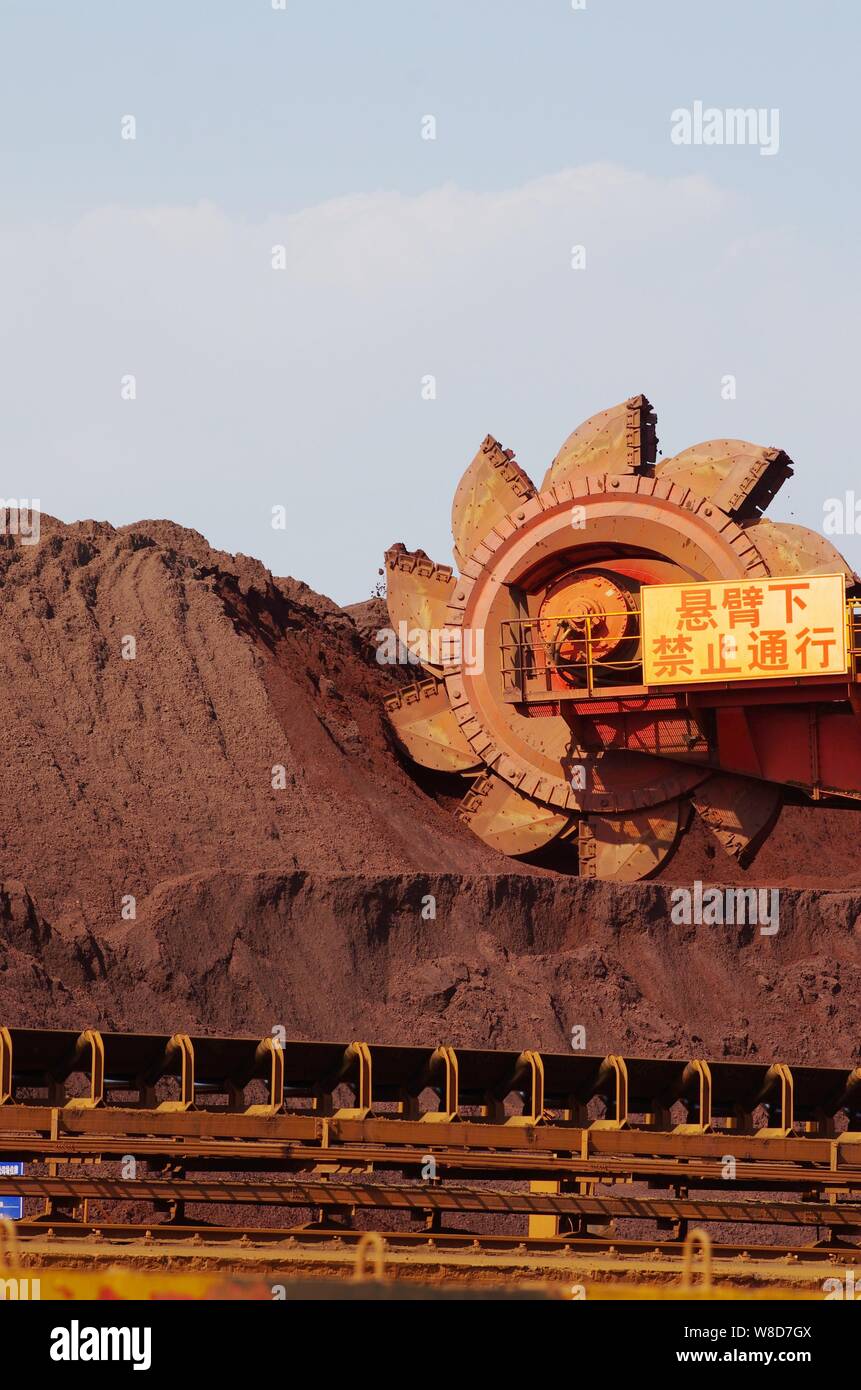 --FILE--A cantilever bucket wheel stacker and reclaimer grips iron ore on a quay at the Port of Rizhao in Rizhao city, east China's Shandong province, Stock Photo