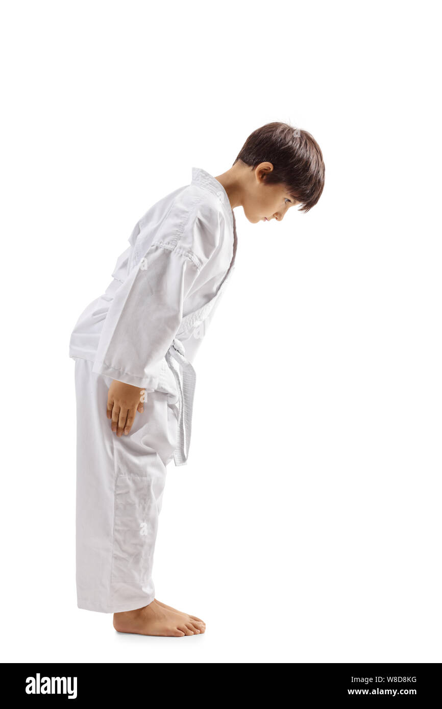 Full length profile shot of a karate kid bowing isolated on white background Stock Photo