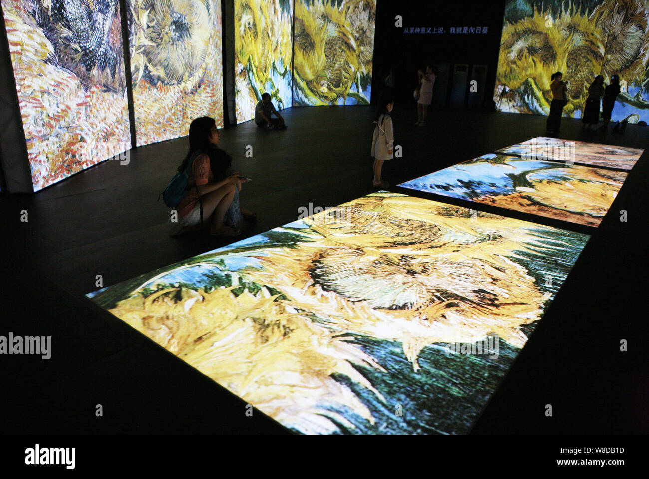 Visitors enjoy a multimedia exhibit of Dutch artist Vincent Van Gogh's ...