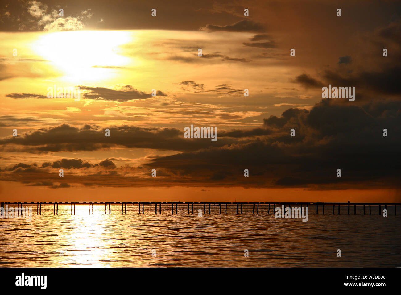 Sunset over wooden jetty in the ocean near Papua New Guinea, southeast