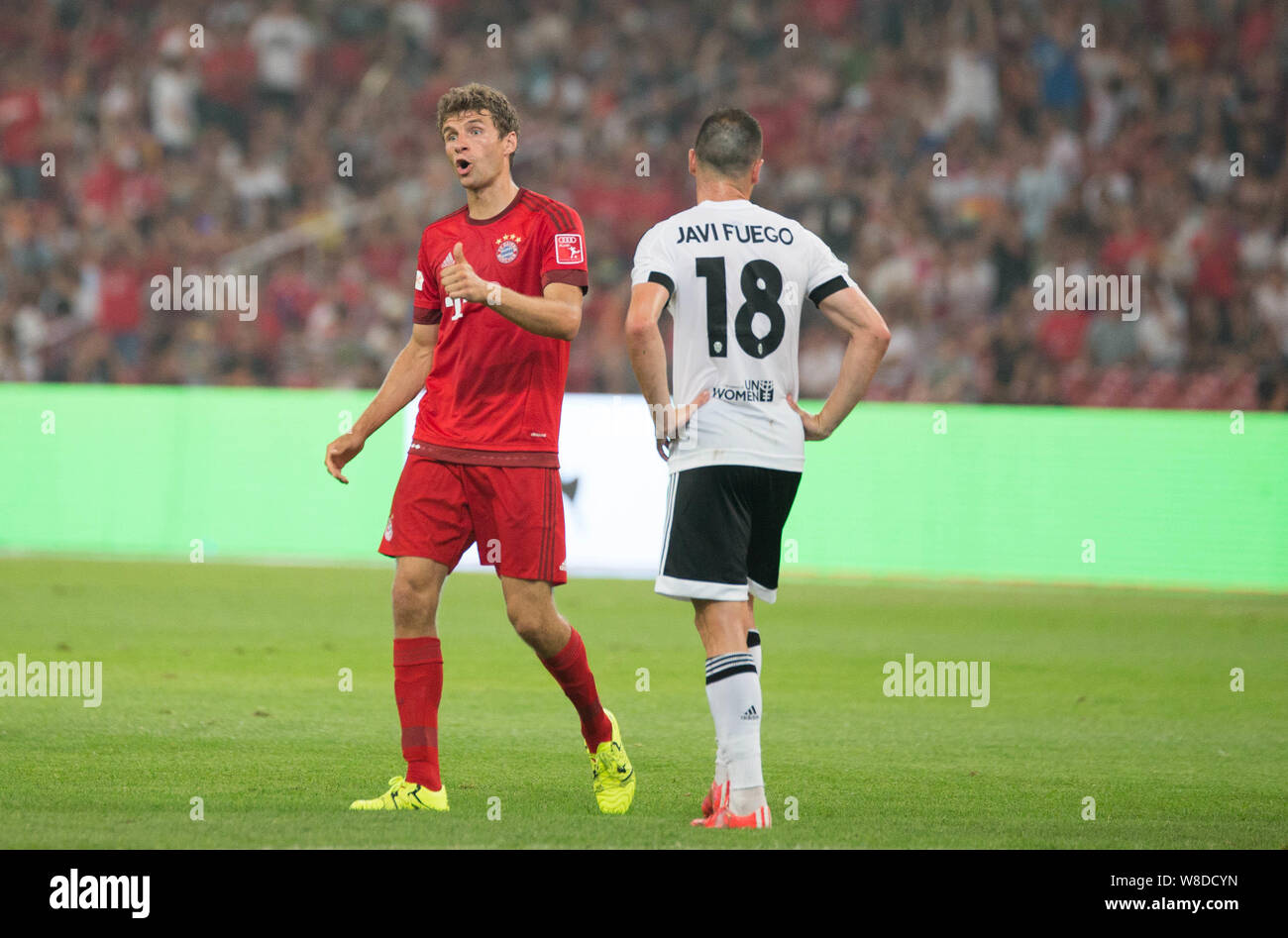 Thomas Mueller of Bayern Munich, left, celebrates next to Javi Fuego of FC Valencia after scoring his second goal against Valencia during their friend Stock Photo