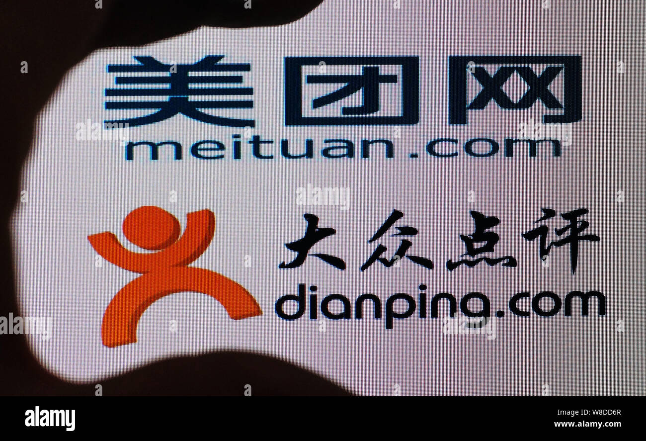 --FILE--A Chinese netizen looks at logos of online group buying site ...