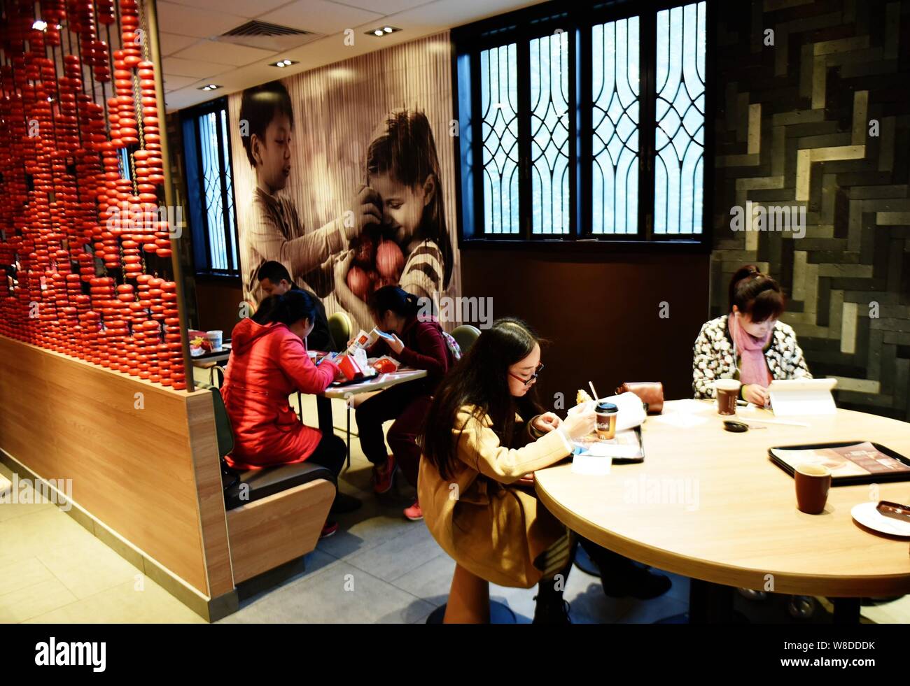 Customers eat at a fastfood restaurant of McDonald's, which was the former Kuomintang leader Chiang Ching-kuo's former residence, in Hangzhou city, ea Stock Photo
