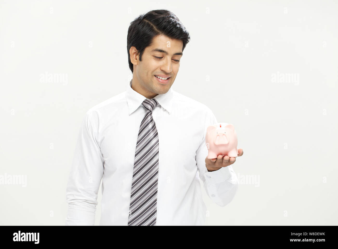 Man smiling piggy bank hi-res stock photography and images - Alamy