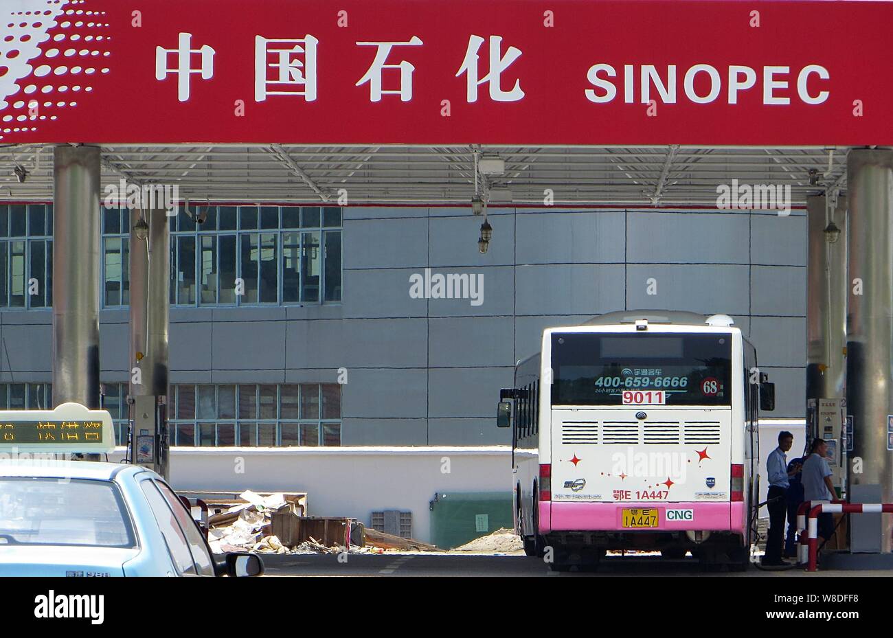 --FILE--A bus is being refueled at a gas station of Sinopec in Yichang city, central China's Hubei province, 24 July 2013.   Asia's largest refiner, C Stock Photo